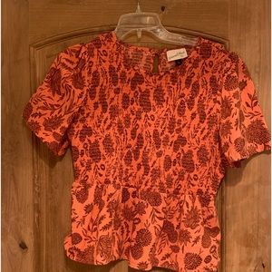 Beautiful vibrant colors. Smocked peplum top.